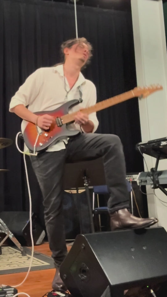 American guitarist playing on eart dmx 10 sunburst color electric guitar