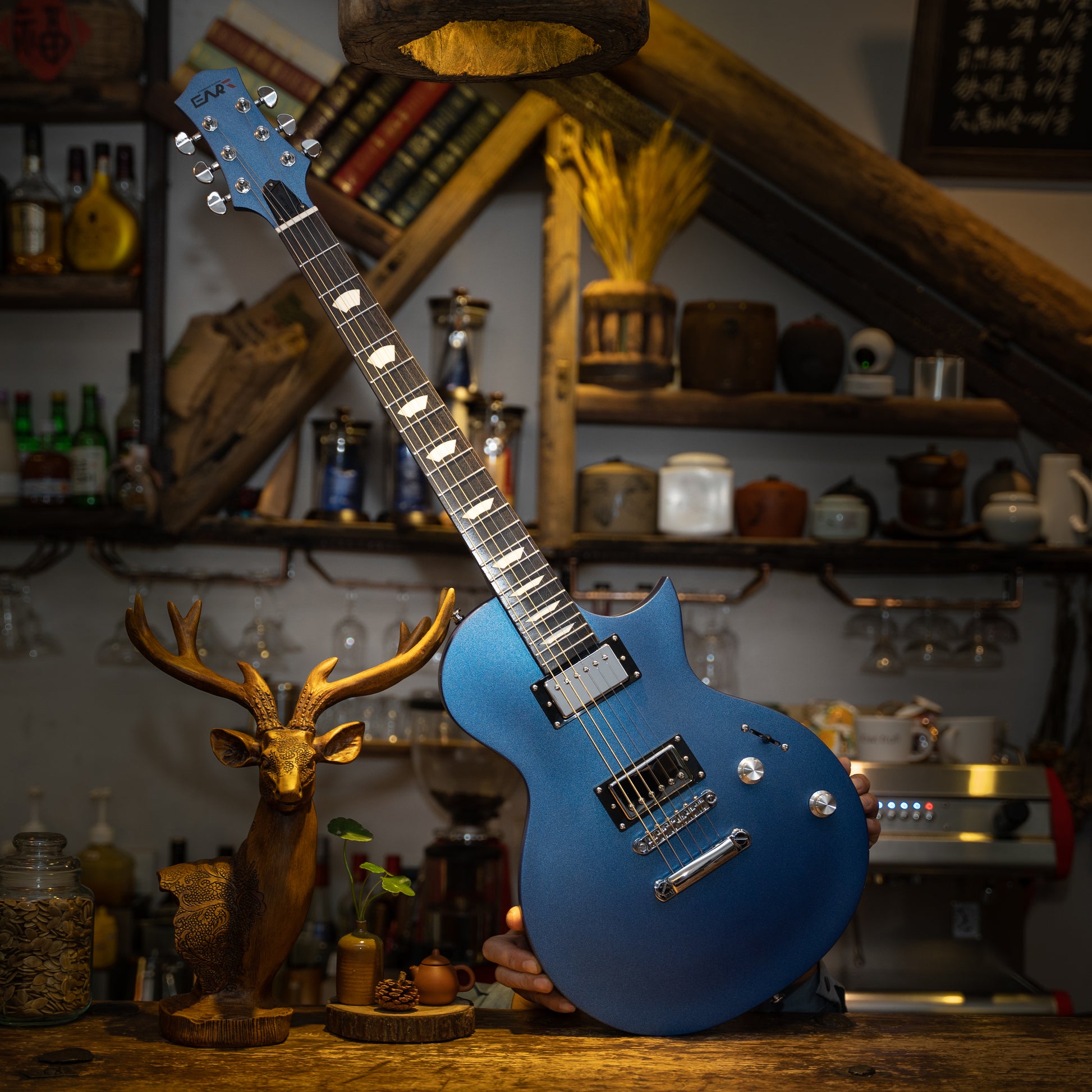 EART electric guitar EGLP-610 blue with a vase